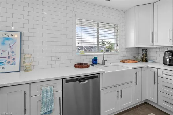 a metallic refrigerator freezer sitting in a kitchen