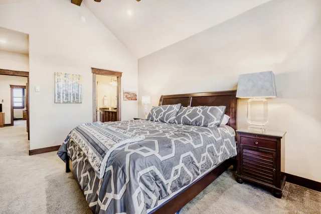 a bedroom with a bed and a dresser next to a window