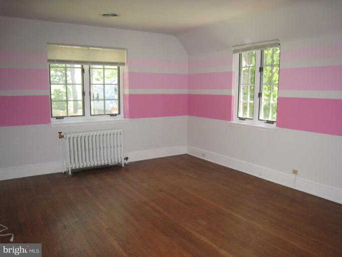907 Old Oak Road Baltimore, MD 21212 - Photo 14 of 28 a view of an empty room with wooden floor and a window