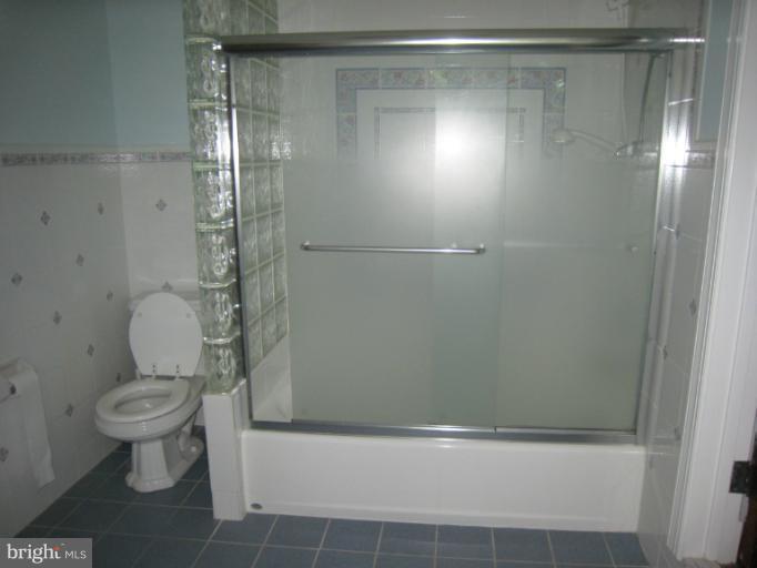 907 Old Oak Road Baltimore, MD 21212 - Photo 23 of 28 a bathroom with a shower a toilet and a shower