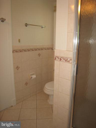 907 Old Oak Road Baltimore, MD 21212 - Photo 6 of 28 a bathroom with a granite countertop toilet and a shower