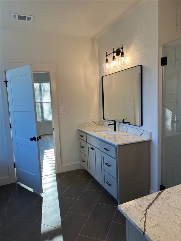 10474 Whiskey River Road Bryan, TX 77808 - Photo 11 of 37 a bathroom with a sink vanity and mirror