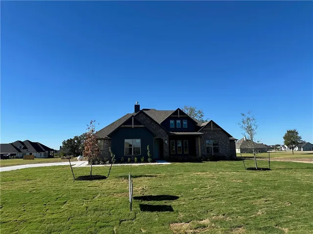 a kitchen with stainless steel appliances kitchen island granite countertop a stove and a sink