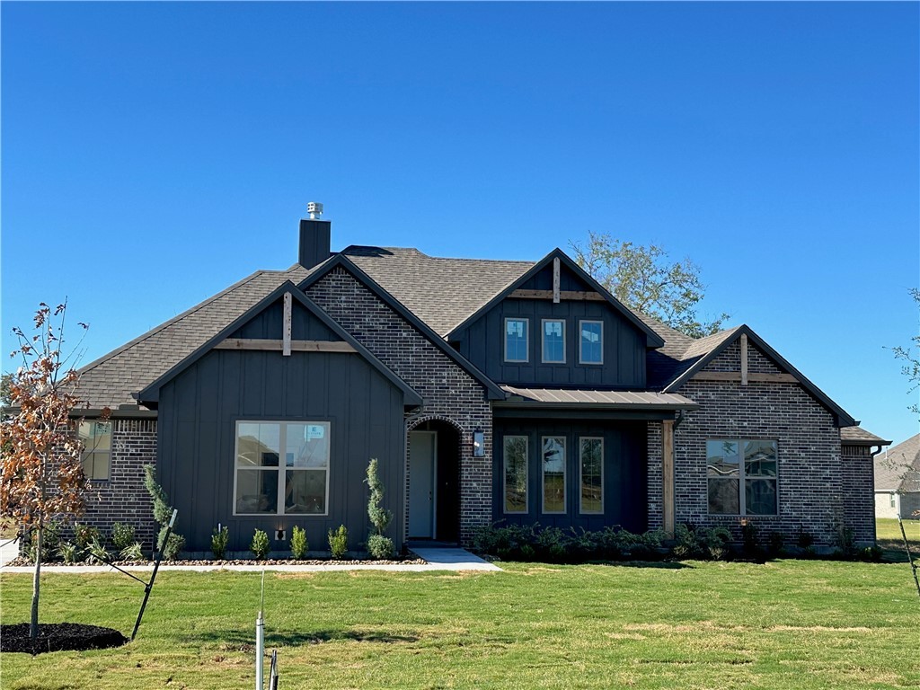 10474 Whiskey River Road Bryan, TX 77808 - Photo 2 of 37 a front view of a house with a yard