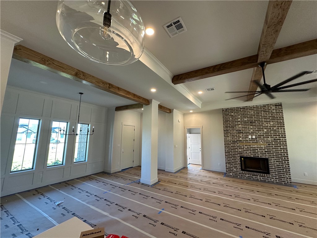 10474 Whiskey River Road Bryan, TX 77808 - Photo 23 of 37 a view of an empty room with a fireplace and a window