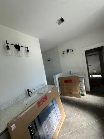 a bathroom with a tub sink and mirror