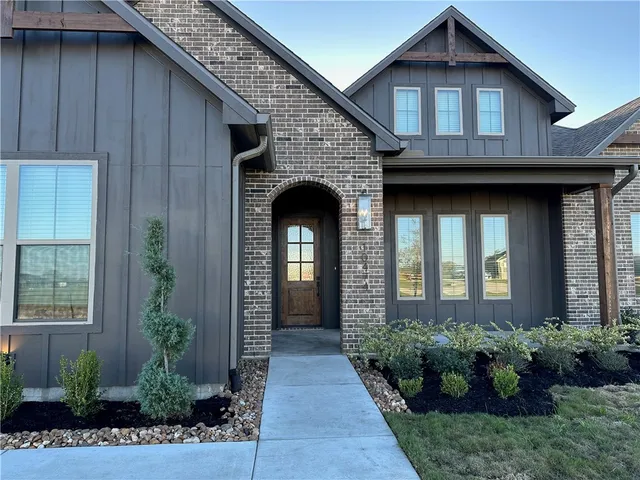 a front view of a house with potted plants