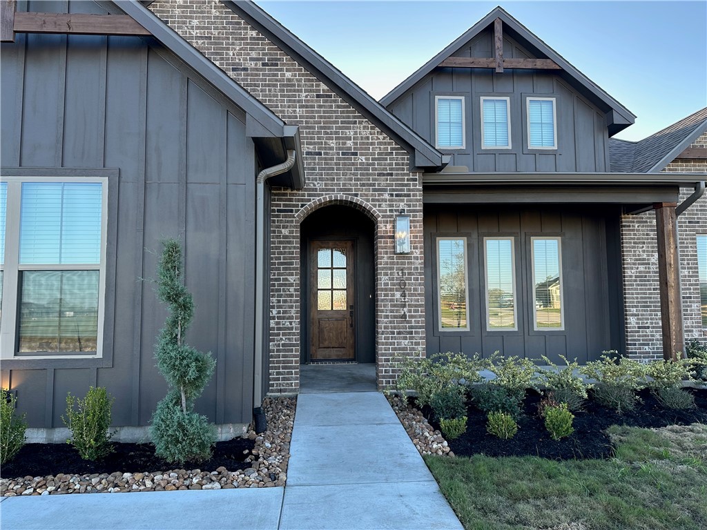 10474 Whiskey River Road Bryan, TX 77808 - Photo 3 of 37 a front view of a house with potted plants