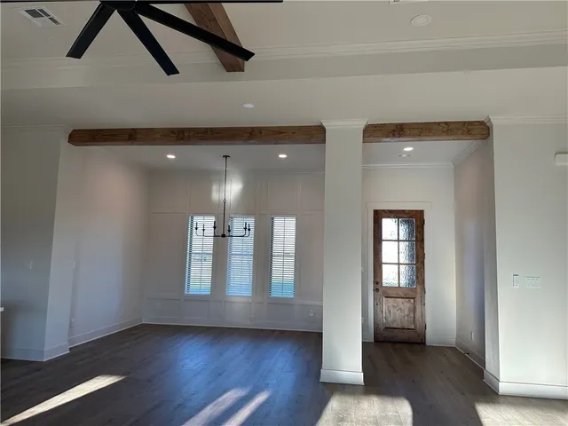 a view of an entryway with wooden floor