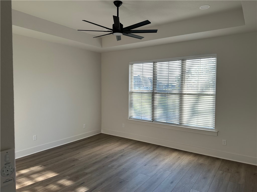 10474 Whiskey River Road Bryan, TX 77808 - Photo 10 of 37 a view of an empty room with wooden floor and a window