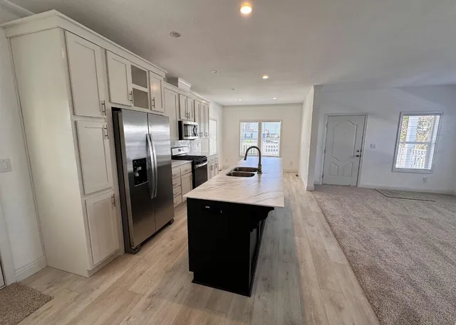 a kitchen with stainless steel appliances a refrigerator and a sink