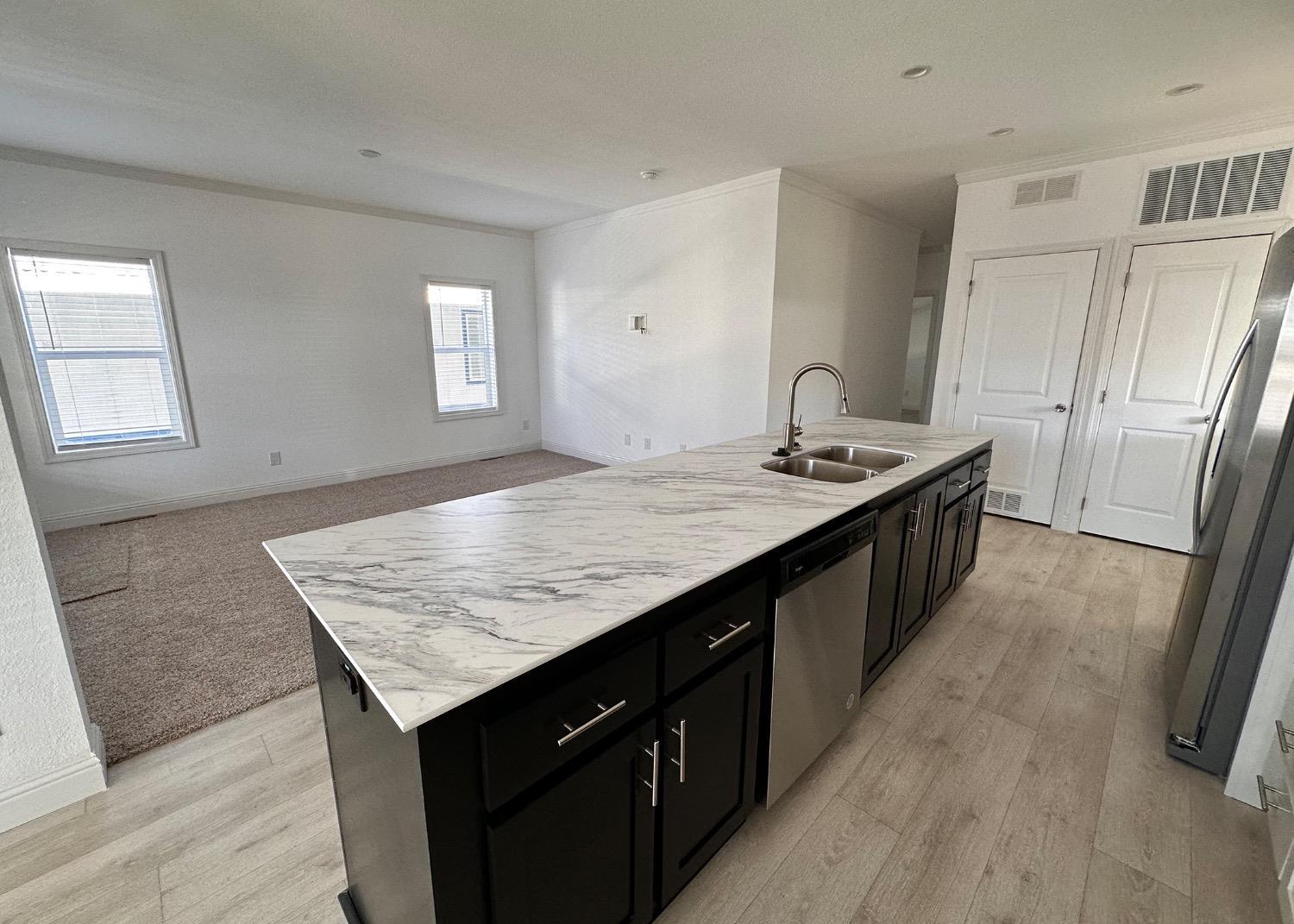 20 Commodore Lane Sacramento, CA 95838 - Photo 4 of 4 a kitchen with granite countertop kitchen island stainless steel appliances a sink stove and wooden floor
