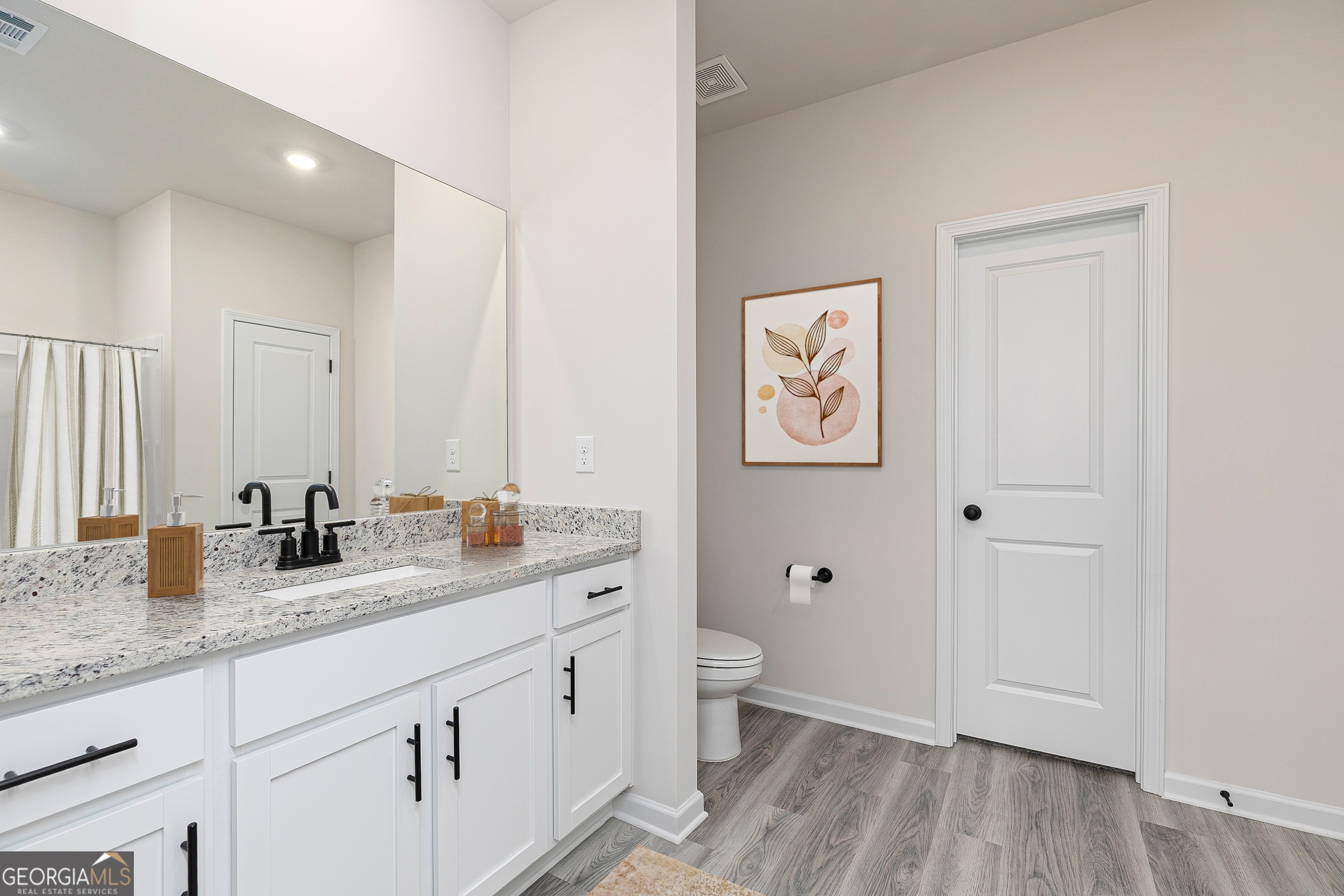 115 Darter Court Jefferson, GA 30549 - Photo 16 of 16 a bathroom with double vanity sink a mirror and a toilet