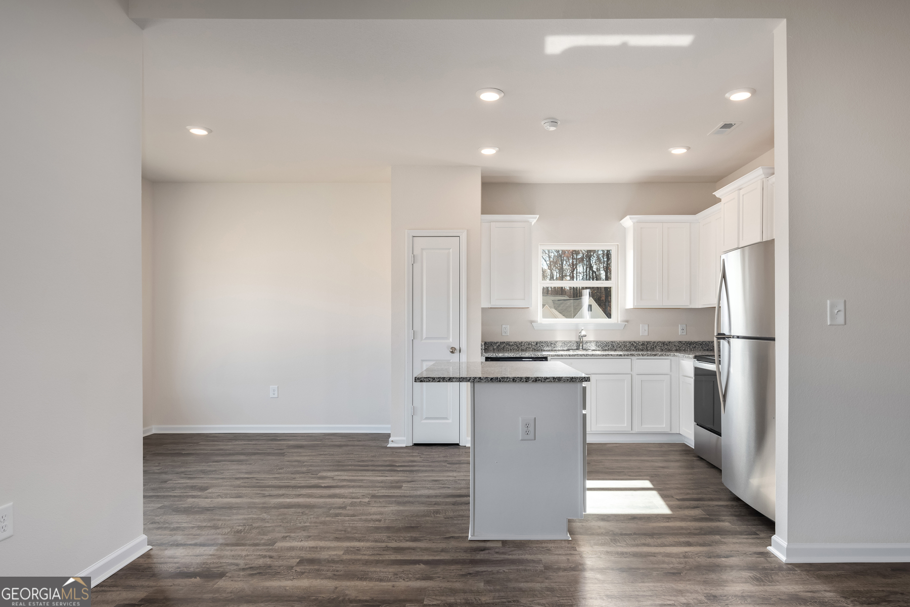 115 Darter Court Jefferson, GA 30549 - Photo 6 of 16 a kitchen with stainless steel appliances granite countertop a sink stove and refrigerator