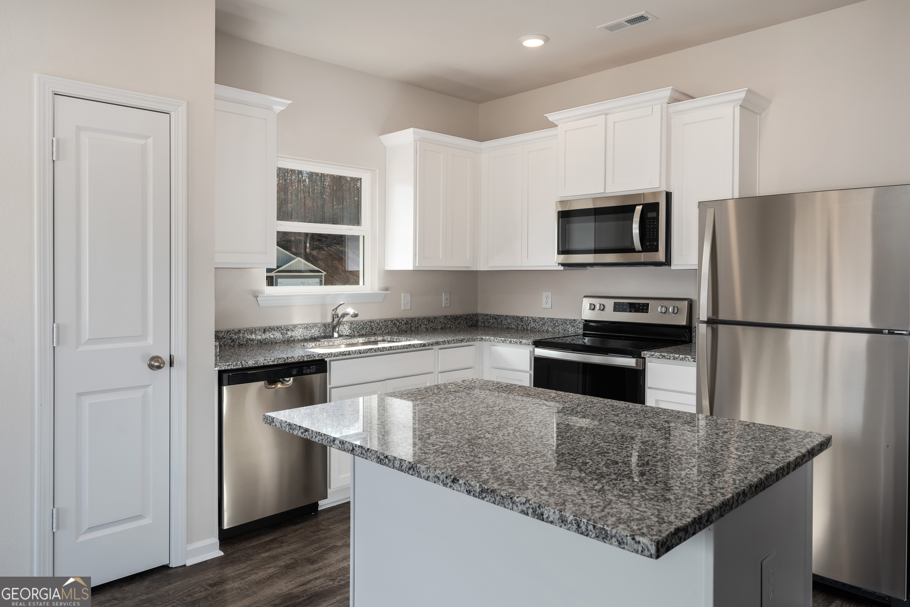 115 Darter Court Jefferson, GA 30549 - Photo 7 of 16 a kitchen with stainless steel appliances granite countertop a sink stove and refrigerator