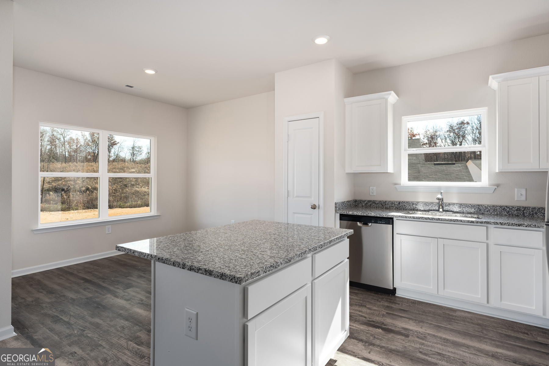 115 Darter Court Jefferson, GA 30549 - Photo 8 of 16 a kitchen with stainless steel appliances granite countertop a sink stove and cabinets