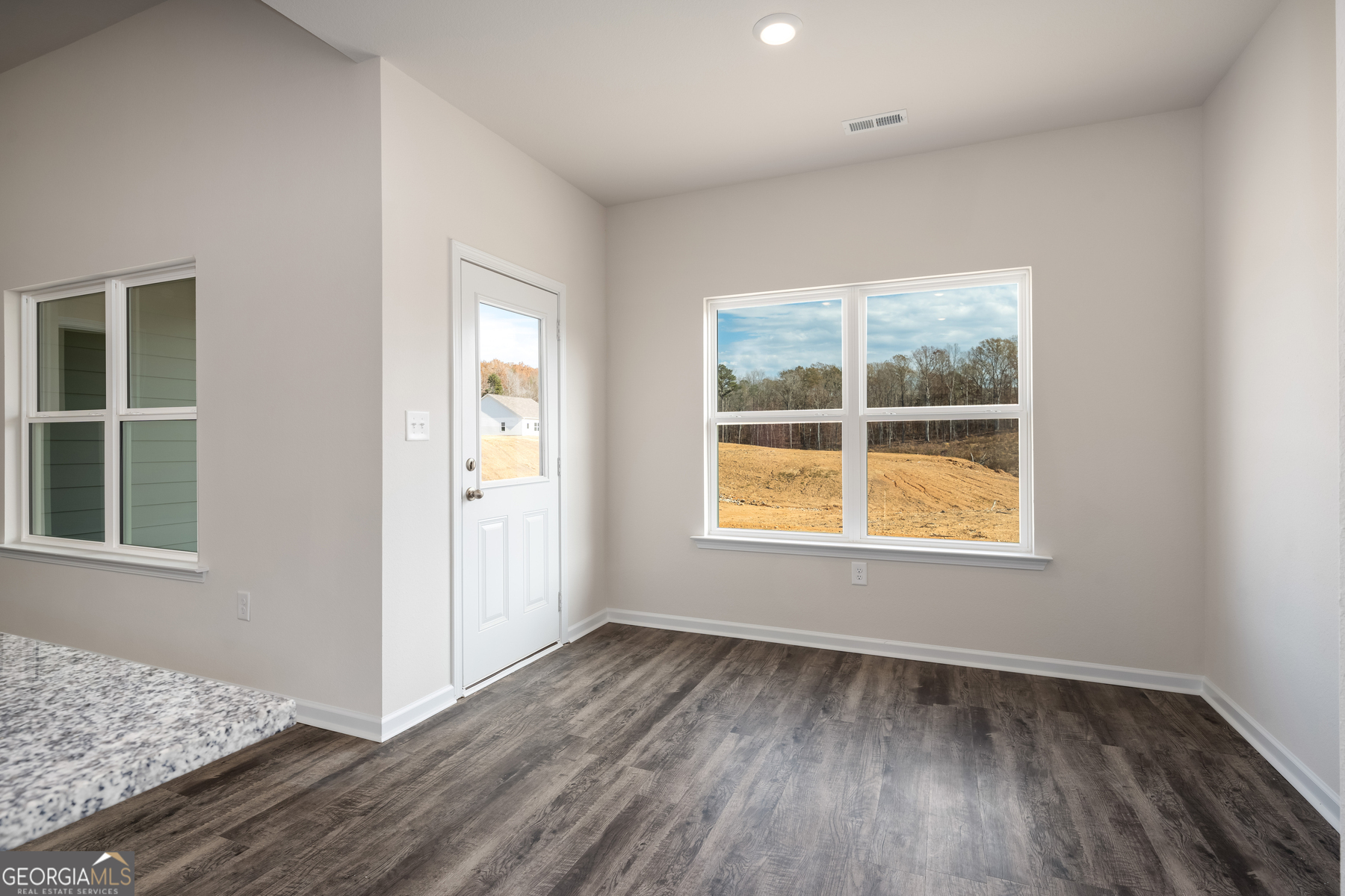 115 Darter Court Jefferson, GA 30549 - Photo 9 of 16 an empty room with wooden floor and windows