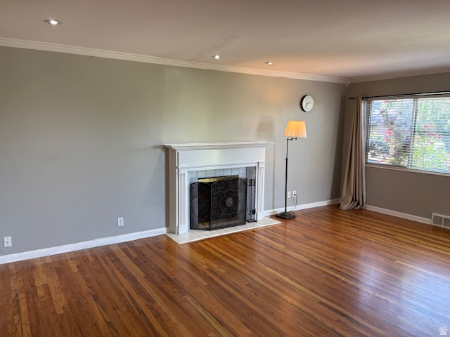 2313 150 East Bountiful, UT 84010 - Photo 4 of 39 Living area featuring wood-finish flooring, a white mantel fireplace with a decorative metal screen, crown molding, and recessed lighting