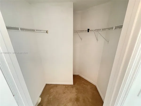 a bathroom with a double vanity sink and mirror with bathtub