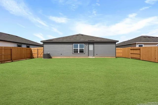 a front view of house with a garden