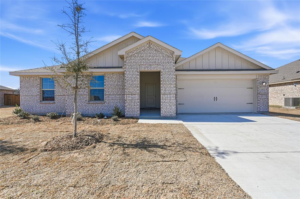1917 Reveille Way Terrell, TX 75160 - Photo 1 of 6 Single-story residence featuring light-colored brick veneer, a two-car garage with an overhead door, and a concrete driveway