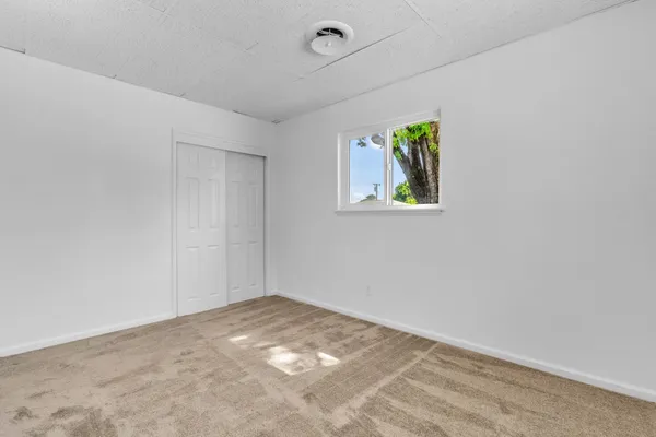 a view of room with window and ceiling fan