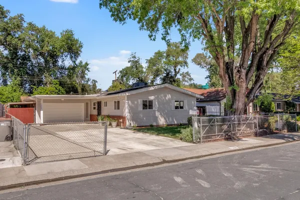 a view of a house with a tree in front of it