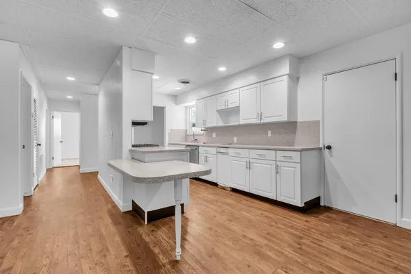 a kitchen with counter top space a sink stainless steel appliances and cabinets