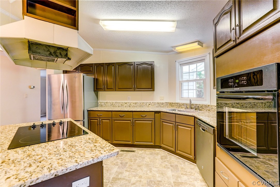 17684 Baltimore Road Dewitt, VA 23840 - Photo 11 of 42 a kitchen with stainless steel appliances granite countertop a sink stove and refrigerator