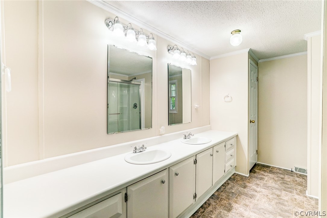 17684 Baltimore Road Dewitt, VA 23840 - Photo 20 of 42 a bathroom with a double vanity sink and mirror