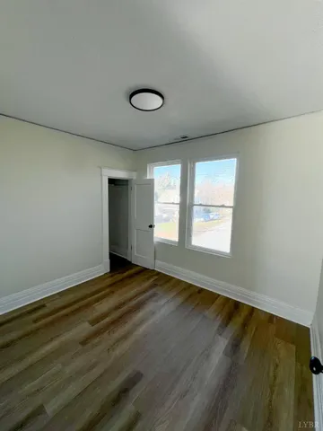 a view of a livingroom with wooden floor and a staircase
