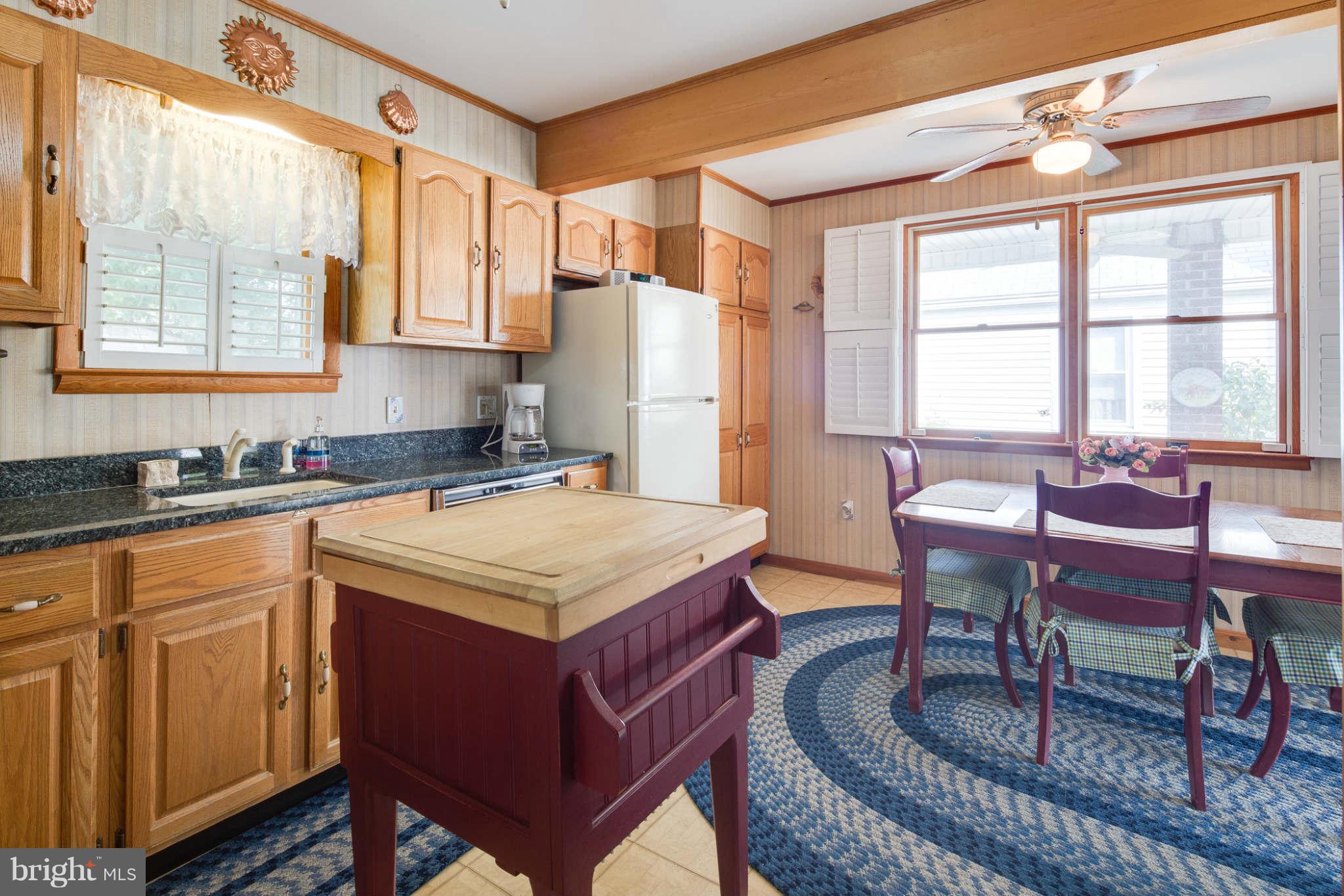 2604 Lynbrook Road Baltimore, MD 21222 - Photo 11 of 30 a kitchen with a stove a sink and a refrigerator