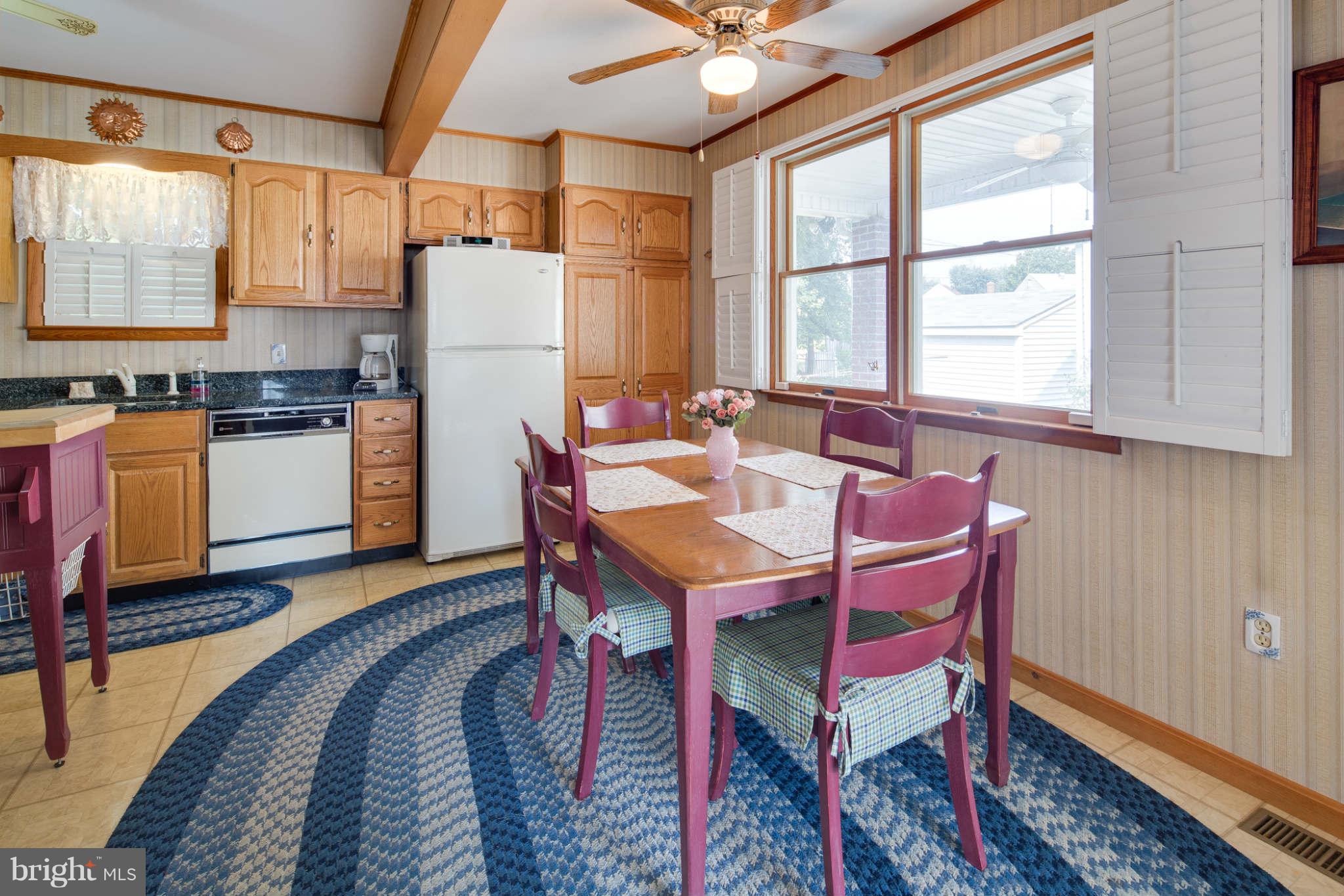 2604 Lynbrook Road Baltimore, MD 21222 - Photo 12 of 30 a dinning table and chairs in a kitchen