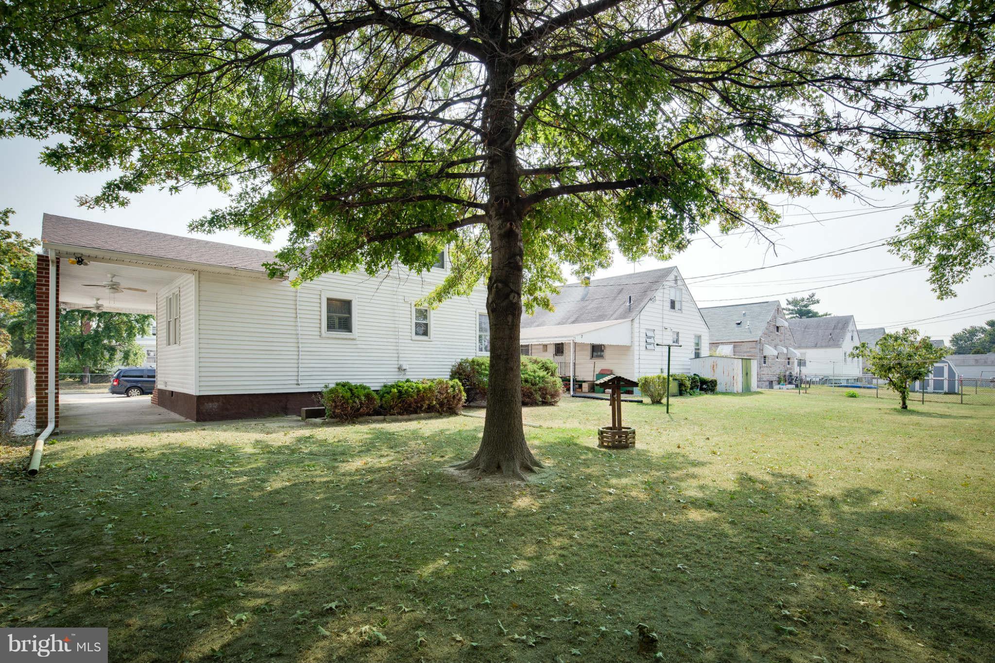 2604 Lynbrook Road Baltimore, MD 21222 - Photo 26 of 30 a view of an house with backyard and trees