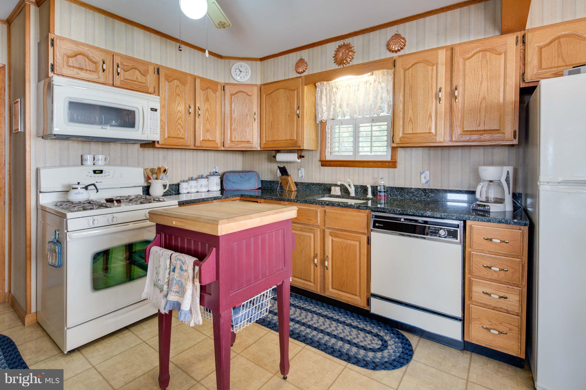 2604 Lynbrook Road Baltimore, MD 21222 - Photo 9 of 30 a kitchen with stainless steel appliances a stove a sink cabinets and a microwave oven