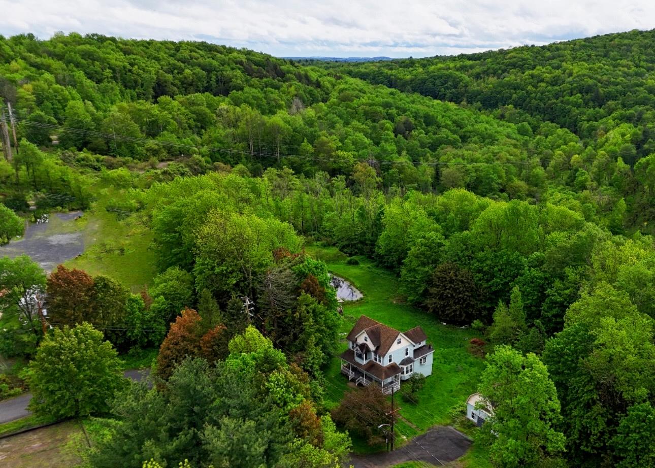 an aerial view of a house with a yard