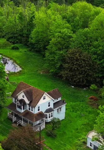 a aerial view of a house with garden space and street view