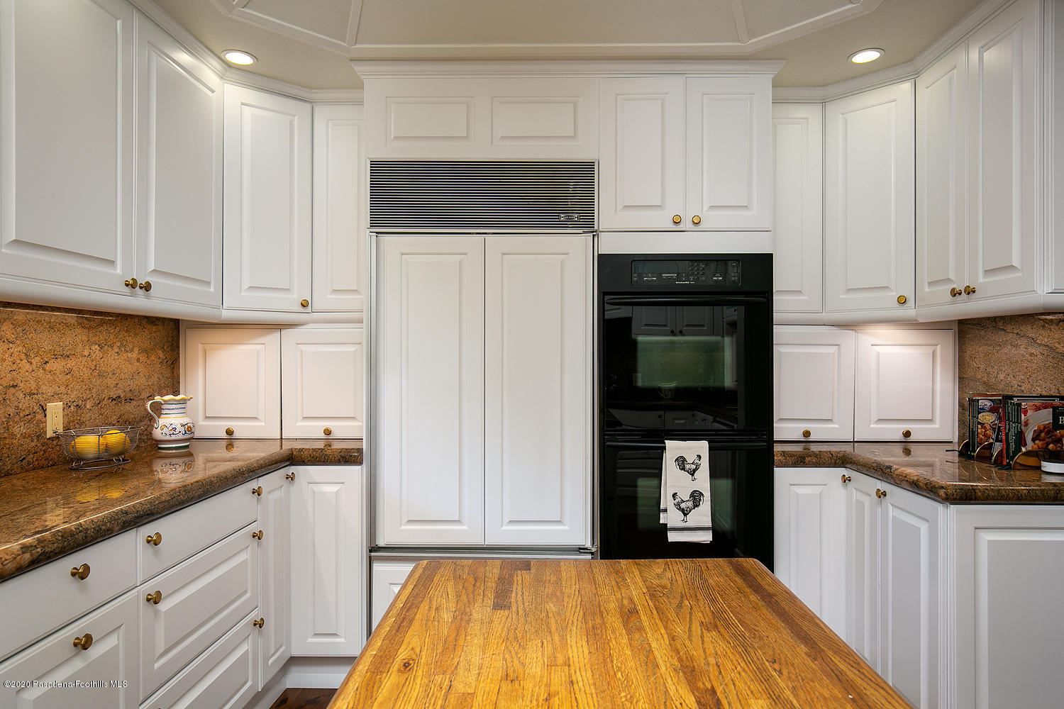 600 Busch Place Pasadena, CA 91105 - Photo 19 of 47 a kitchen with granite countertop a refrigerator sink and cabinets