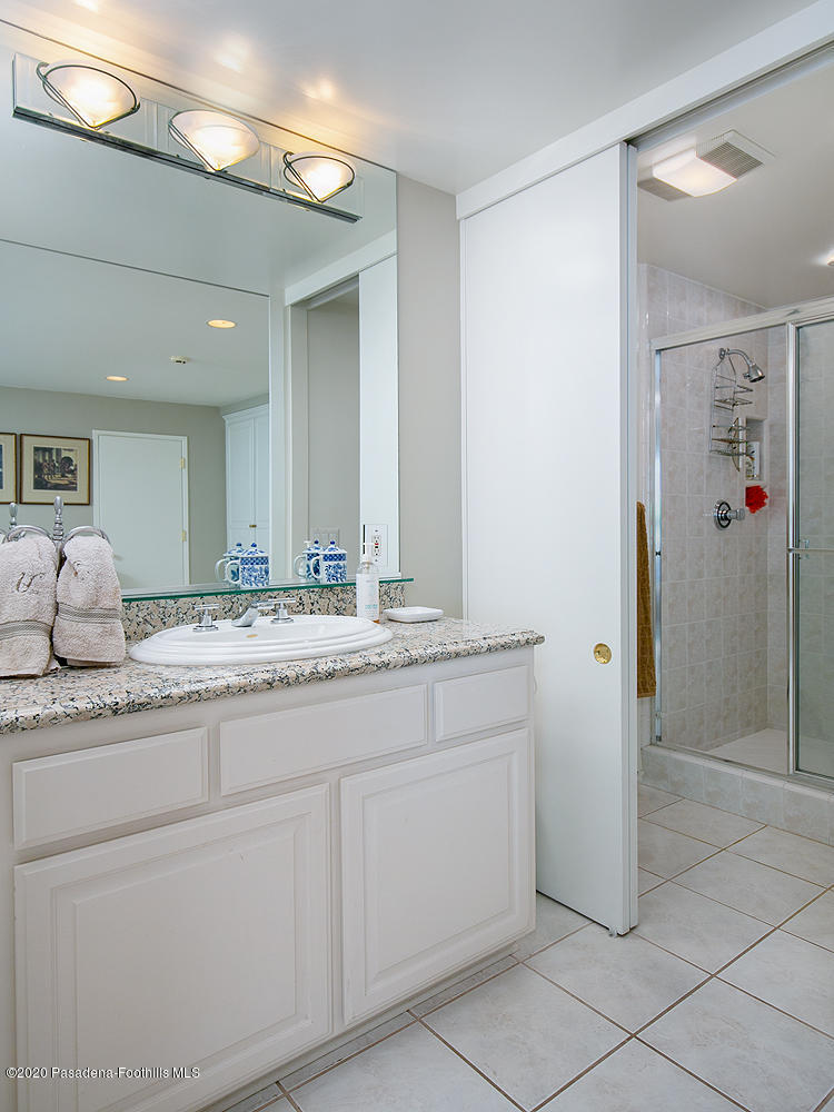 600 Busch Place Pasadena, CA 91105 - Photo 27 of 47 a bathroom with a granite countertop sink and a mirror