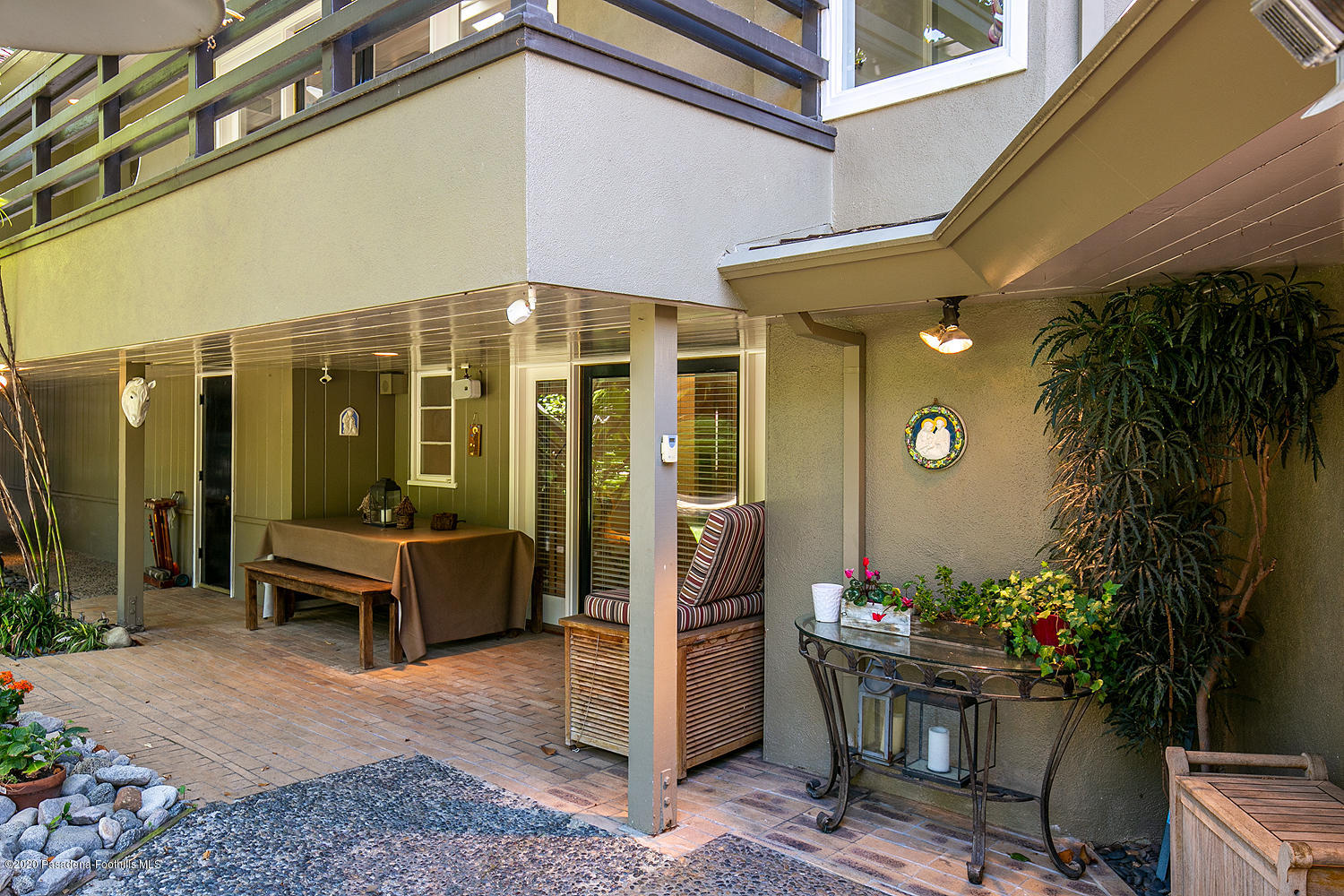 600 Busch Place Pasadena, CA 91105 - Photo 35 of 47 a patio with a table and chairs and potted plants