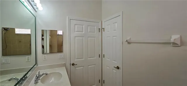 a front view of a house with a garden and yard