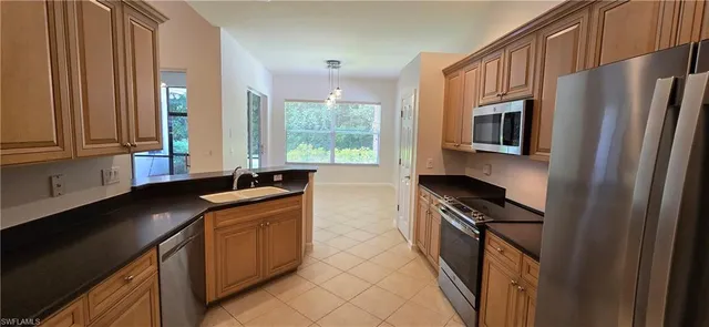 a kitchen with stainless steel appliances a sink stove and refrigerator