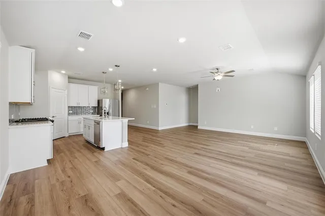 a view of kitchen view with wooden floor and stainless steel appliances