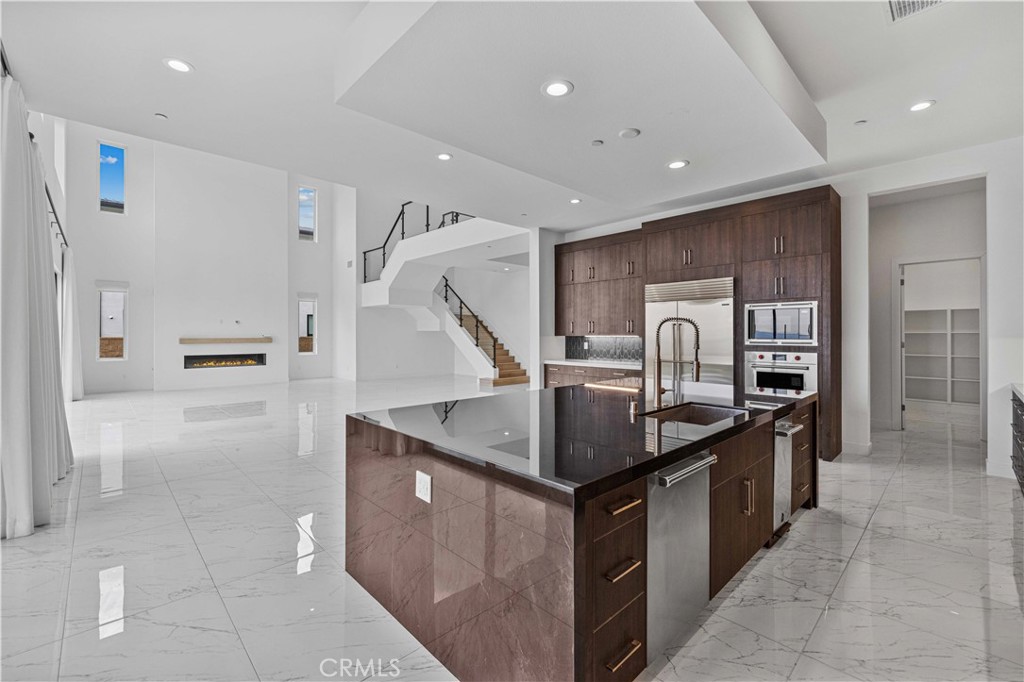 11752 Hillsborough Lane Porter Ranch, CA 91326 - Photo 11 of 45 a kitchen with stainless steel appliances granite countertop a sink and a refrigerator