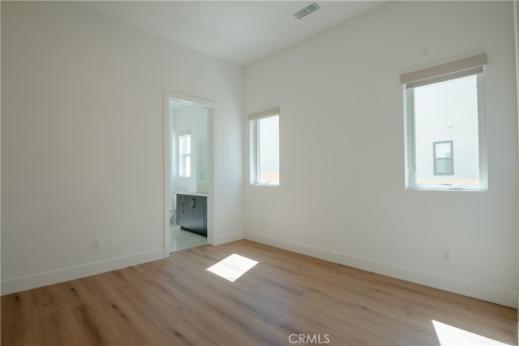 11752 Hillsborough Lane Porter Ranch, CA 91326 - Photo 18 of 45 an empty room with wooden floor and windows