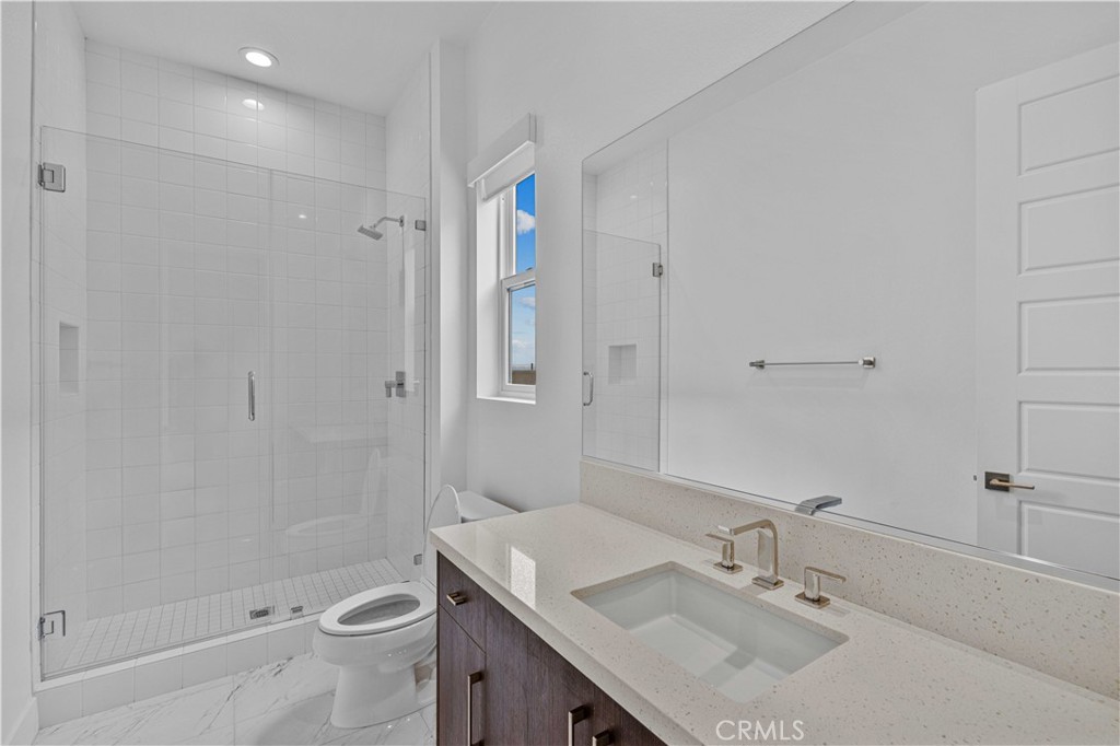 11752 Hillsborough Lane Porter Ranch, CA 91326 - Photo 19 of 45 a bathroom with a sink toilet and shower