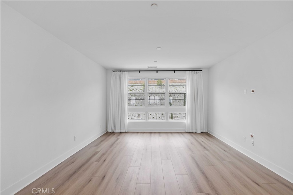 11752 Hillsborough Lane Porter Ranch, CA 91326 - Photo 22 of 45 wooden floor in an empty room with a window