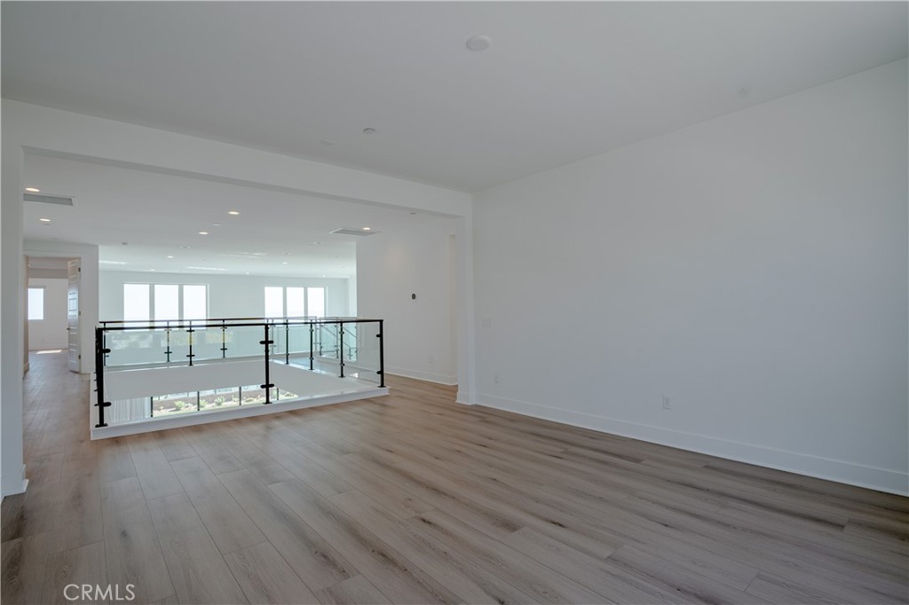 11752 Hillsborough Lane Porter Ranch, CA 91326 - Photo 23 of 45 wooden floor in an empty room with a window