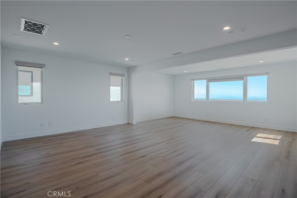 11752 Hillsborough Lane Porter Ranch, CA 91326 - Photo 25 of 45 a view of an empty room with wooden floor and a window