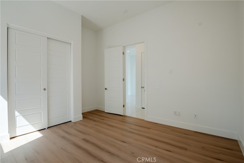 11752 Hillsborough Lane Porter Ranch, CA 91326 - Photo 36 of 45 a view of an empty room with wooden floor